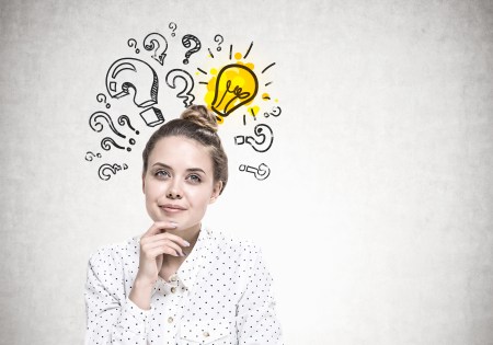 Smiling young woman dreaming, answer